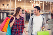 © luckybusiness - happy young couple in shopping