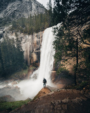 Man Overlooking Waterfall In Yosemite National Park