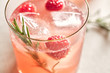 Fresh homemade mocktail with red fruits and rosemary.