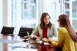 © Stocksy - Smiling Businesswoman Discussing With Colleague