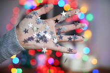 Hand Covered In Silver Star Confetti