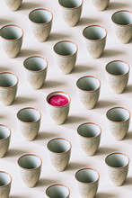 Pattern Of Empty Mugs With Just One Mug With Beetroot Juice