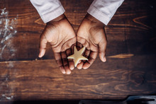 Black Girl's Hands Holding A Star Shaped Cookie Dough