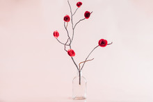 Red Paper Roses On A Twig In A Vase