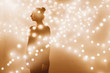 © Stocksy - Silhouette of a woman in lights