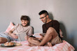 © Stocksy - Men reading books on bed