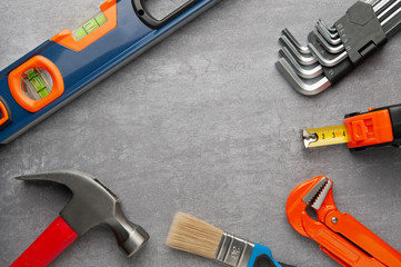 Hand tools on grey background  maintenance concept. Hex wrenches hammer brush with text space.