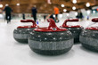 © Stocksy - Curling: Red Team Stones Wait On Ice