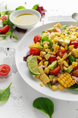 Wall Mural - Sweet Corn salad with tomatoes, avocado, red onion, herbs and lime