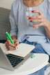 © Stocksy - Woman using laptop indoor