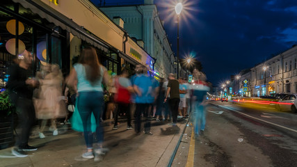 people have fun on the city streets on a summer evening on Saturday