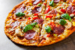 © pavel siamionov - Pizza with Chicken meat, Mozzarella cheese, pepperoni, tomato, vegetables, salami. Italian pizza on wooden background