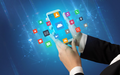 Female hand using smartphone with colorful application icons around