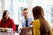 © Stocksy - Businesswoman Showing Laptop To Colleagues