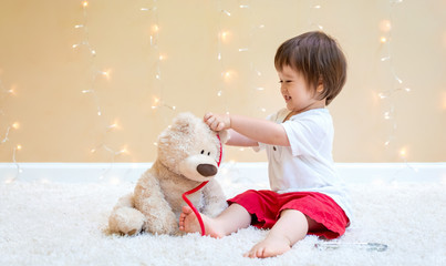 Toddler boy with teddy bear doctor pediatric theme