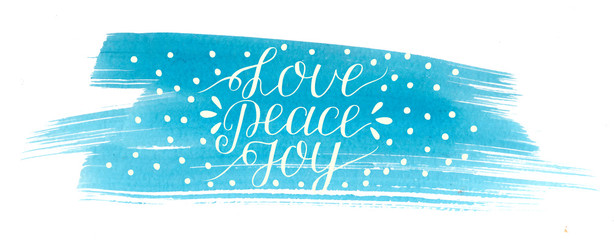 Wall Mural - Holiday christmas inscription Love, peace, joy, made hand lettering on blue watercolor background