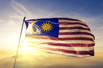 Wall Mural - Malaysia Malaysian flag textile cloth fabric waving on the top sunrise mist fog