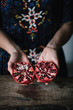 © Stocksy - Woman showing bright pomegranate halves
