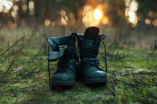 Hiker Old Black Boots Standing On Grass Hard Travel Concept