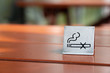  No smoking sign displayed on a wood table in the restaurant