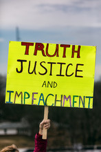 Protest: Person Holds Up Sign Calling For Impeachment
