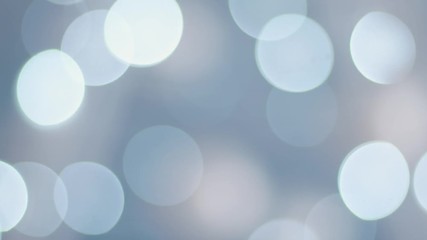 Blue defocused lights - loop. Abstract blurred blue bokeh background of garland. Blinking Christmas Tree Lights Twinkling. Winter Holidays Concept.