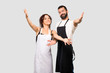 © luismolinero - Couple of cooks presenting and inviting to come. Happy that you came on grey background