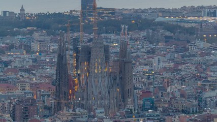 Wall Mural - Sagrada Familia, a large church in Barcelona, Spain night to day timelapse