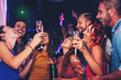 © Alessandro Biascioli - Group of friends dancing and drinking champagne at nightclub party - Happy young people having fun celebrating together in disco club - Entertainment, nightlife and youth lifestyle