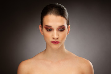 Beauty portrait of a gorgeous young brunette woman over gray background