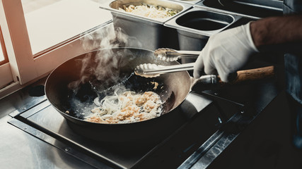 Close up. Worker Cooking Tasty Food in Food Truck.