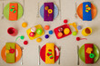 © COLOR PHOTO - Multicolored plates and linen napkins with knitted decor. Table setting for the autumn or winter cold season - Thanksgiving, Halloween, Christmas and New Year.