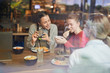 © pressmaster - Cute girls making funny selfie by lunch while spending time in fast food cafe