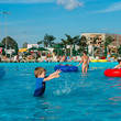 © smspsy - baby boy splashing in the pool in the water park