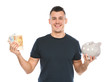 Portrait of young man with piggy bank and money on white background