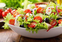 Bowl Of Fresh Salad With Vegetables And Greens