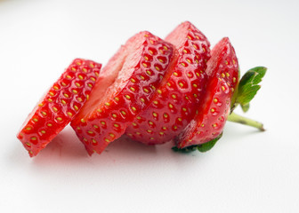 Fresh raw strawberries on blue background.