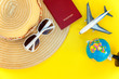 Leinwandbild Motiv Flat Lay with hat, plane, passport, globe and sunglasses on yellow colourful trendy modern fashion background. Vacation travel summer weekend sea adventure trip concept