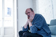 © SB Arts Media - Sad unhappy old senior man suffering from memory loss and alzheimer feeling depressed and lonely