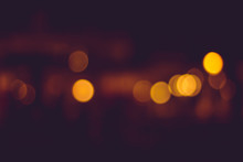 Blurry Distant City Lights At Night. Calm Yellow Blurry Traffic Lights In The Distance