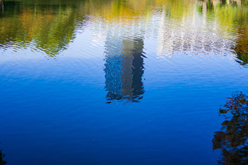 Wall Mural - Reflection of buildings and maple trees on a pond in Japanese garden (Koishikawa Korakuen, Tokyo, Japan)