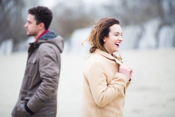 Young beautiful couple  together outdoors at cold windy weather