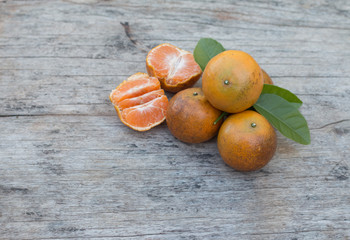 Wall Mural - Closeup of fresh orange fruit on wooden table background