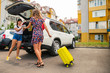 © phpetrunina14 - two woman packing luggage in car trunk