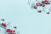 Christmas Or Winter Composition. Frame Made Of Snowflakes And Red Berries On Pastel Blue Background. Christmas, Winter, New Year Concept. Flat Lay, Top View, Copy Space