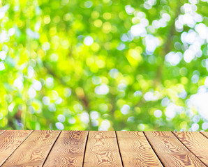 Wall Mural - world environment day concept: empty wooden table over blurred tree with bokeh background