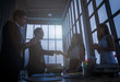 © saksit - Silhouettes of business partners handshaking with man . handshake of business concept.