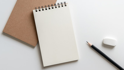 open blank spiral notebook with pencil and eraser on white background.empty space for your text.