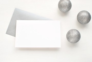 Blank card and envelope with silver Christmas balls. Greeting card mock up.