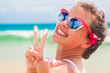 © el.rudakova - Close up of young woman in sunglasses putting sun cream on shoulder